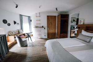a bedroom with a large bed and a couch at Apart Hotel Wasserturm in Bad Segeberg