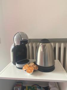 a coffee maker and a tea kettle on a shelf at Hotel Beretta in Perledo