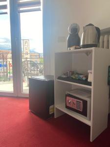 a white cabinet with a radio in a room at Hotel Beretta in Perledo