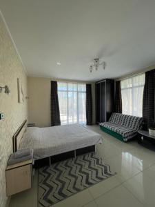 a large bedroom with two beds and a couch at Тownhouse99 in Petropavlovskaya Borshchagovka