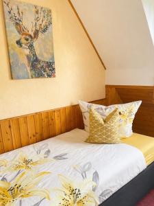 a bed with a picture of a deer on the wall at Ferienhaus mit 3 Apartments - Belle Apartment - Top-Lage, Sauna, HS-Card in Feldberg