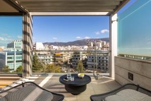 a balcony with a view of a city at Golden Age Athens Hotel in Athens