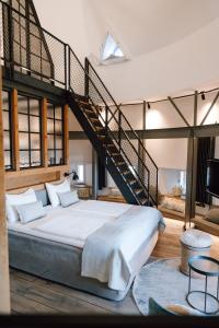 a bedroom with a large bed with a staircase at Apart Hotel Wasserturm in Bad Segeberg