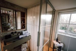 a bathroom with a shower and a sink and a mirror at Apart Hotel Wasserturm in Bad Segeberg +88 photos