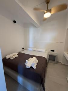 a bedroom with a bed with two towels on it at MIRA house in Ios Chora