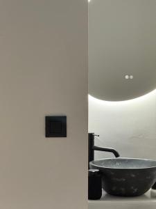 a bathroom with a bowl sink and a lamp at MIRA house in Ios Chora