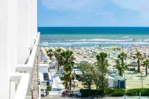 a view of the beach from the balcony of a resort at Hotel Kursaal in Rimini