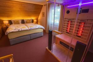 a bedroom with a bed and a glass wall at Ferienhaus mit 3 Apartments - Belle Apartment - Top-Lage, Sauna, HS-Card in Feldberg