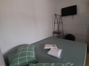 a bedroom with a bed with two towels on it at Casa completa - Ótimo Custo-benefício in Itajaí