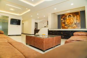 a living room with a couch and a coffee table at Hotel KS Palace in Varanasi