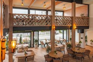 a restaurant with tables and chairs and a balcony at Hotel Mondo in Budva