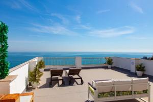 a balcony with chairs and a view of the ocean at Lighthouse Cullera Penthouse in Cullera
