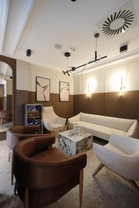 a living room with a couch and a table at Hotel Botika in Kraljevo