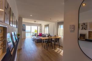 a living room with a table and a couch at Lighthouse Cullera Penthouse in Cullera