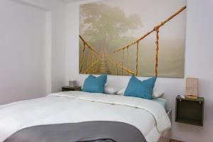 a bedroom with a bed and a suspension bridge at Lighthouse Cullera Penthouse in Cullera