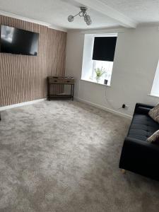 a living room with a couch and a window at Towerknowe in Hawick