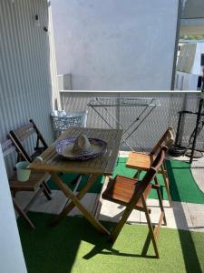a wooden table and chairs on a balcony at Auberge Chambre La Bienveillance in Lormont