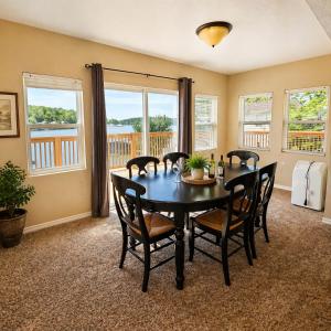 a dining room with a table and chairs and windows at Buccaneer Bay #28 - Beachfront Bliss in Sunrise Beach