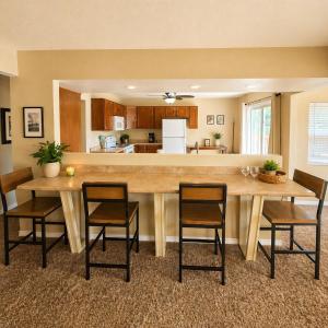 a kitchen with a large wooden table and chairs at Buccaneer Bay #28 - Beachfront Bliss in Sunrise Beach