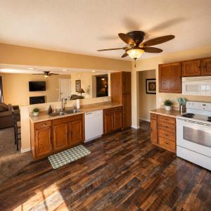 a kitchen with wooden cabinets and a ceiling fan at Buccaneer Bay #28 - Beachfront Bliss in Sunrise Beach +9 photos
