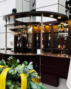 a bar with a counter with bottles of alcohol at Crossway Hotel Baku in Baku