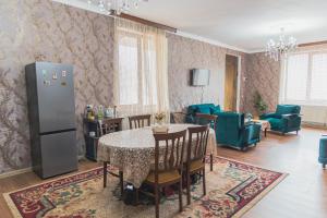 a kitchen and dining room with a table and chairs at Strawberry in Borjomi