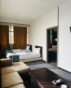 a hotel room with a bed and a couch at Crossway Hotel Baku in Baku +74 photos