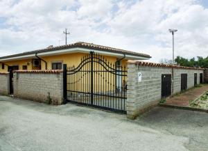 a yellow house with a gate in front of it at Escape Anzio- intero appartamento in Anzio