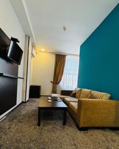 a living room with a couch and a table at Crossway Hotel Baku in Baku