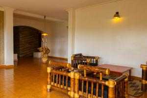 a living room with a wooden table and chairs at UmuTea Villa - Authentic East African local experience in Kigali +45 photos