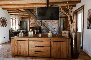 a wooden dresser in a living room with a tv at Apart Hotel Wasserturm in Bad Segeberg