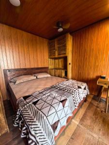 a bedroom with a bed in a wooden wall at The Beachbreaks Medewi in Airsatang