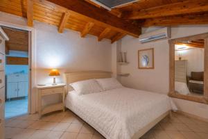 a bedroom with a bed and a table with a lamp at Casa Corallina in Olbia