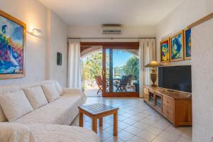 a living room with a couch and a tv at Casa Corallina in Olbia