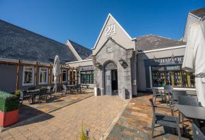 a patio with tables and chairs in front of a building at Temple Gate Hotel in Ennis