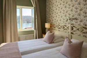 a hotel room with a bed with a window at Hotell Nostalgi in Motala +22 photos