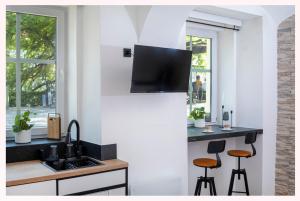 a kitchen with a sink and a counter with stools at The 1826 Residence in Ljubljana