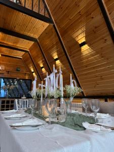 a table with white candles on top of it at Darchi • დარჩი in Batumi