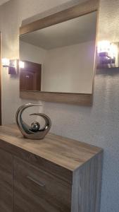 a bathroom counter with a mirror and a sink at Panoramaferienwohnung Bergwiese in Masserberg