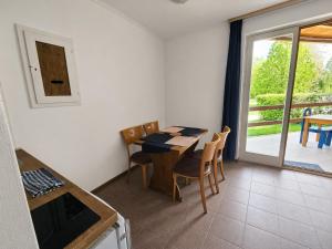 a dining room with a table and chairs and a balcony at Dömös Danu Kemping in Dömös
