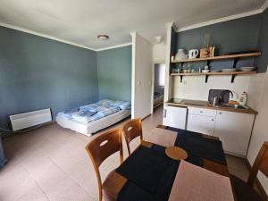 a small room with a table and a bed at Dömös Danu Kemping in Dömös