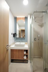 a bathroom with a sink and a shower at Hotel Botika in Kraljevo +42 photos