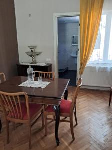 a dining room table with two chairs and a table with glasses on it at Guest House Ucha in Mtskheta
