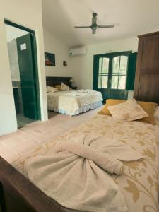 a bedroom with two beds and a mirror at Finca La Media Luna in San Agustín de Valle Fértil +40 photos