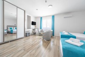 a bedroom with two beds and a large mirror at Hotel Mondo in Budva