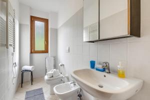 a white bathroom with a sink and a toilet at Residence La Perla with Shared Pool in Monte Isola