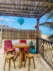 a wooden table and chairs on a patio at Casa Mar Alto in Icapuí