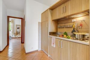 a kitchen with wooden cabinets and a counter top at Residence La Perla with Shared Pool in Monte Isola