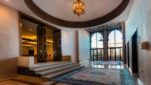 a lobby with a chandelier and large windows at Zalagh Kasbah Hotel & Spa in Marrakesh