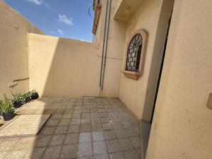 an empty hallway of a building with a window at ANA Apartment in Hail